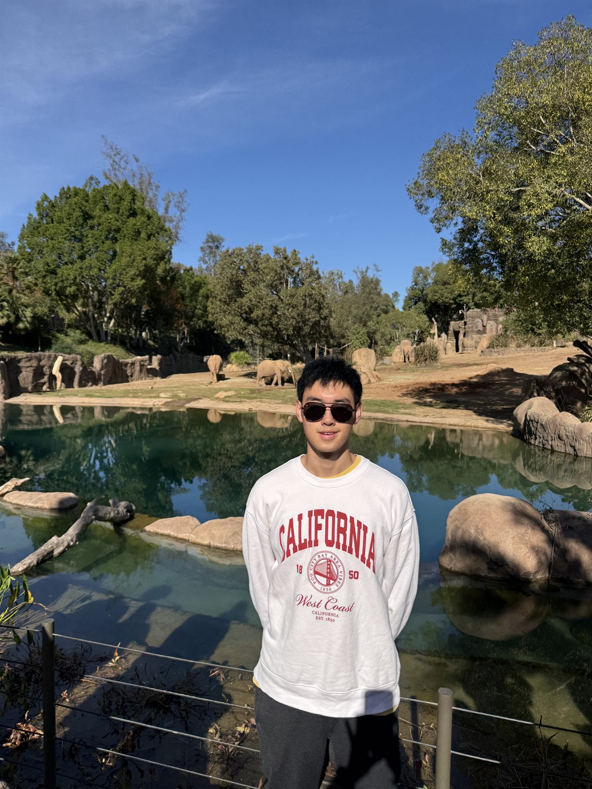 William Cheng standing in front of the elephant enclosure at the San Diego Zoo Safari Park