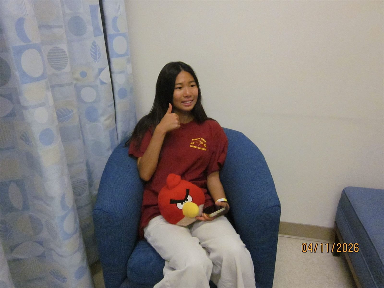 Ellie Kim in a Torrey Pines Science Olympiad shirt, giving a thumbs up